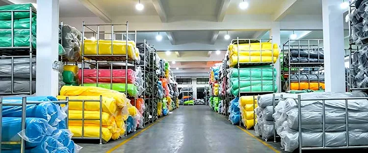 Large raw material warehouse with colorful bulk microfiber fabric rolls for wholesale car cleaning accessories stock management